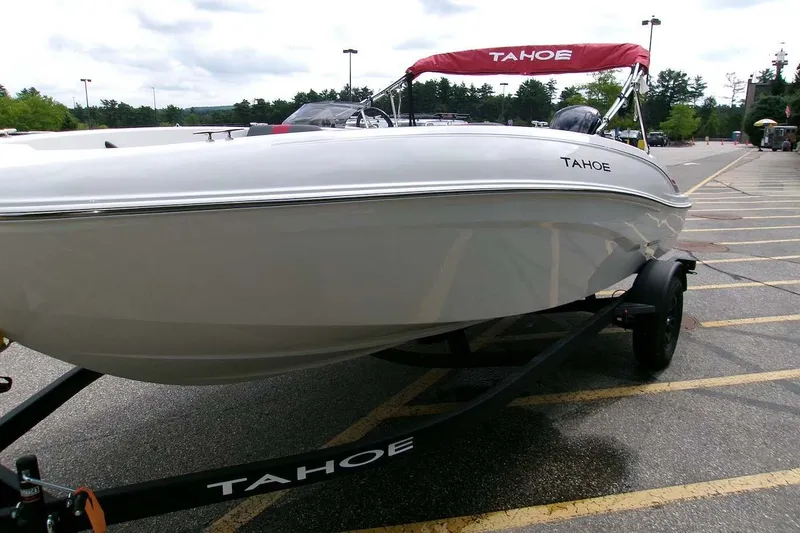 Slide: The Image of 2027 Tahoe T18 boat on trailer in parking lot, overcast sky. - 3