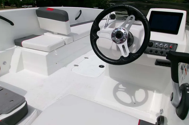 Slide: The Image of Interior of a 2027 Tahoe T18 boat featuring steering wheel and control panel. - 6