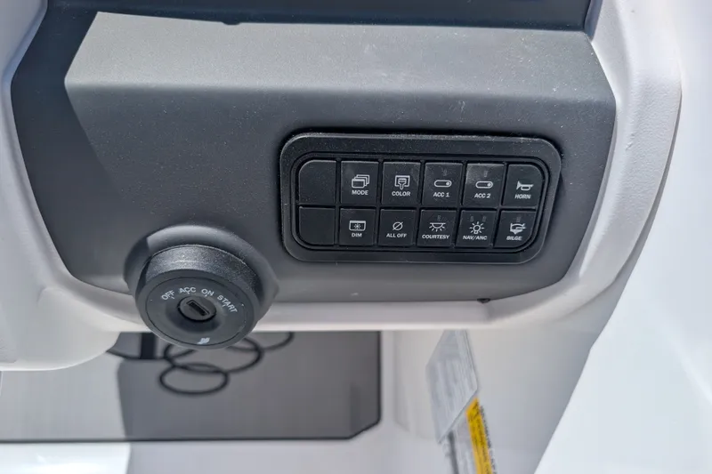 Slide: The Image of Dashboard controls of a 2027 Tahoe T21 boat, featuring ignition and function buttons. - 15