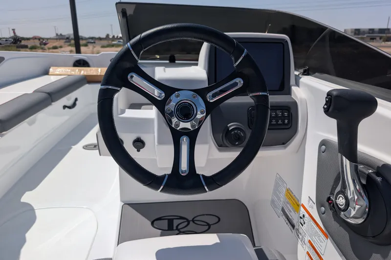Slide: The Image of Steering wheel and controls of a 2027 Tahoe T21 boat, showcasing modern design. - 14