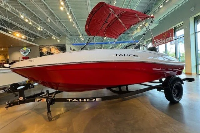 Slide: The Image of 2027 Tahoe T16 boat with red hull and canopy on display in showroom. - 1