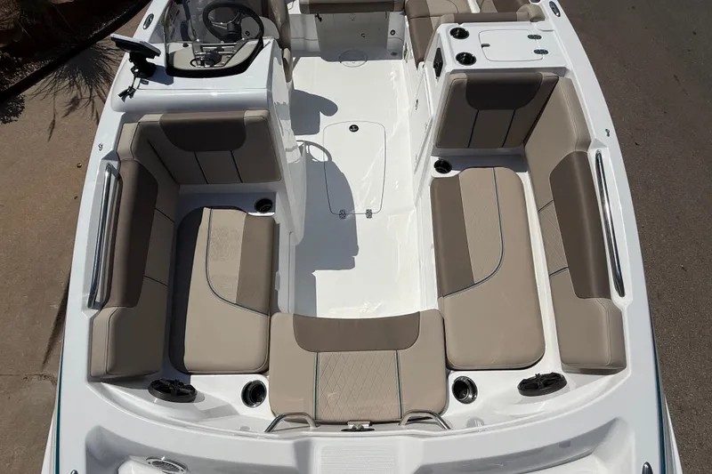 Slide: The Image of 2027 Tahoe 1950 boat interior with beige seating and modern dashboard design. - 10