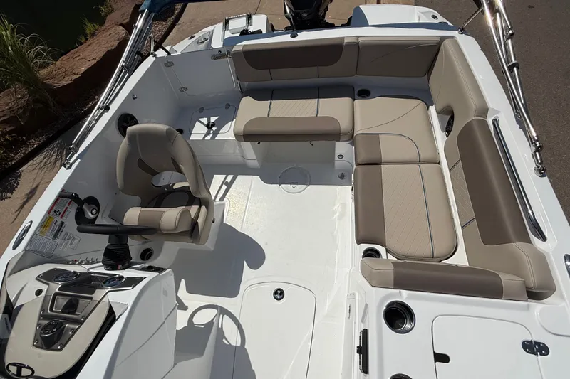 Slide: The Image of Interior view of a 2027 Tahoe 1950 boat featuring beige seating and modern controls. - 11