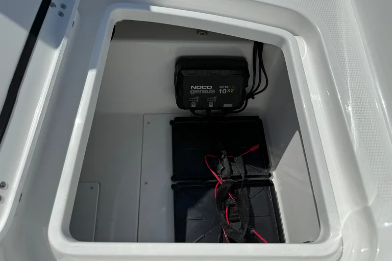 Slide: The Image of Battery compartment of a 2027 Tahoe 1950 boat with NOCO Genius charger. - 14