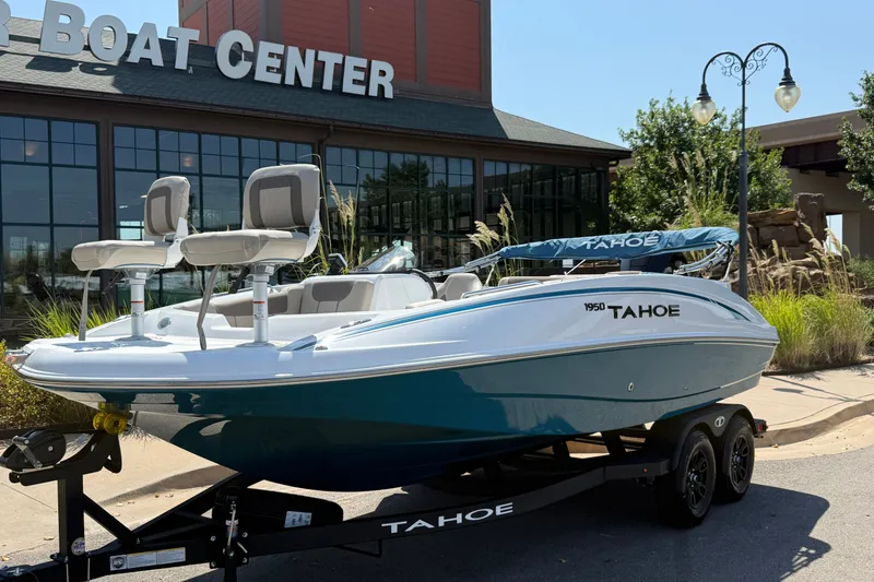 Slide: The Image of 2027 Tahoe 1950 boat displayed at a boat center, showcasing sleek design and modern features. - 2