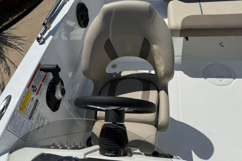 Slide: The Image of Steering area of a 2027 Tahoe 1950 boat with beige seating and controls. - 13