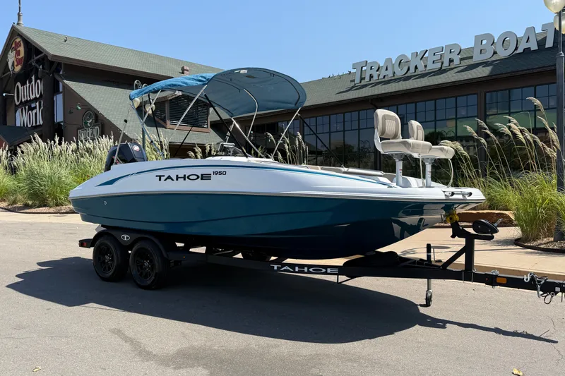 Slide: The Image of 2027 Tahoe 1950 boat on trailer outside Tracker Boats store. - 17