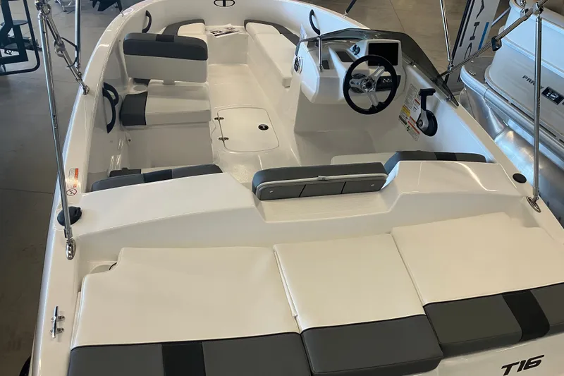Slide: The Image of 2027 Tahoe T16 boat interior with seating and steering wheel, showcasing modern design. - 2