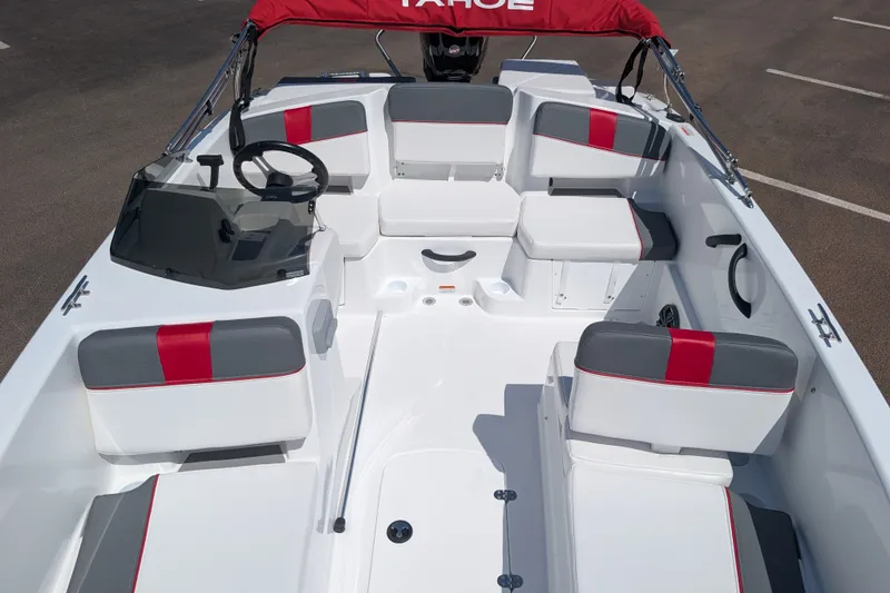 Slide: The Image of 2027 Tahoe T18 boat interior with red and gray seating, steering wheel, and canopy. - 12