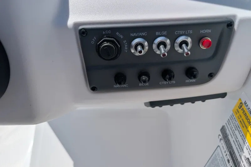 Slide: The Image of Control panel of a 2027 Tahoe T18 boat with switches and labels. - 14