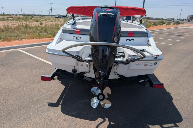 Slide: The Image of 2027 Tahoe T18 boat with Mercury outboard motor in a parking lot. - 6