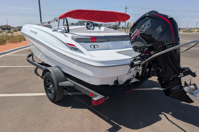 Slide: The Image of 2027 Tahoe T18 boat with red canopy and powerful outboard motor on trailer. - 7