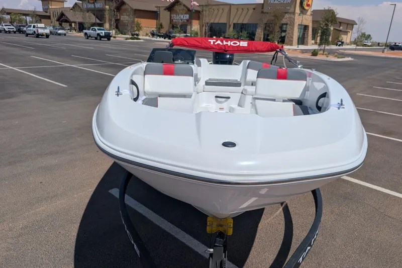 Slide: The Image of 2027 Tahoe T18 boat in parking lot, featuring sleek design and red accents. - 2