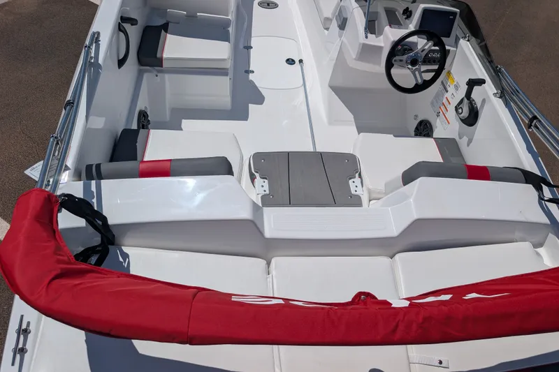 Slide: The Image of 2027 Tahoe T18 boat interior with steering wheel, seating, and red accents. - 8
