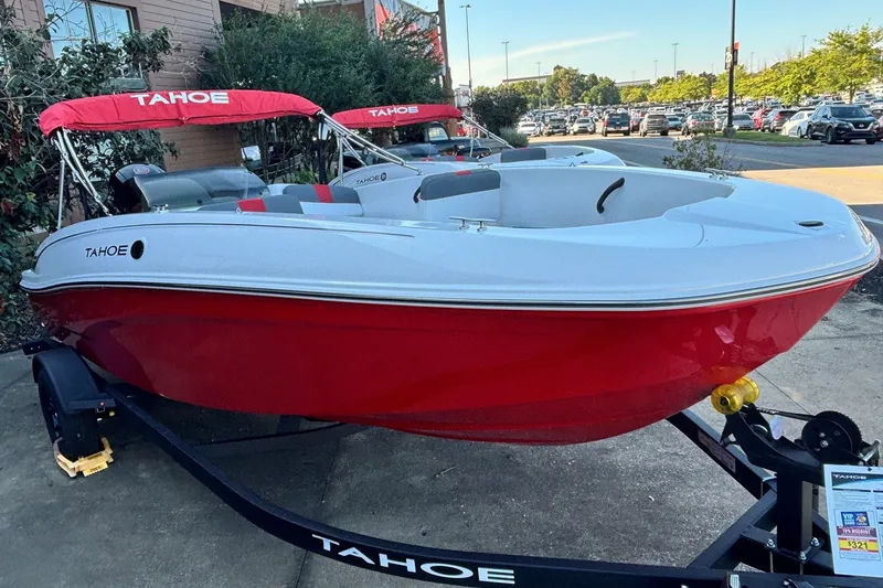 Slide: The Image of 2027 Tahoe T18 boat with red hull and canopy on a trailer in a parking lot. - 3