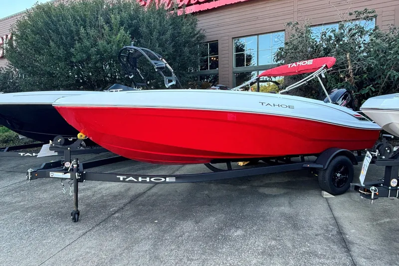 The Image of 2027 Tahoe T18 boat in vibrant red on a trailer, parked outdoors. - 0