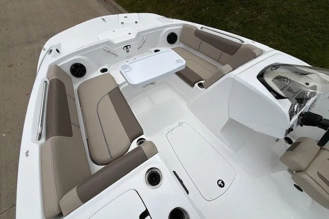 Slide: The Image of 2027 Tahoe 1950 boat interior with beige seating and a white table. - 111