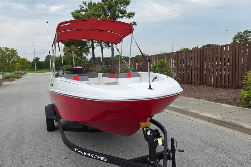 Slide: The Image of Red 2027 Tahoe T18 boat on trailer with canopy, parked on a street. - 7