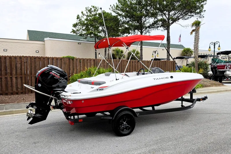 Slide: The Image of 2027 Tahoe T18 boat with red hull and canopy on trailer. - 1