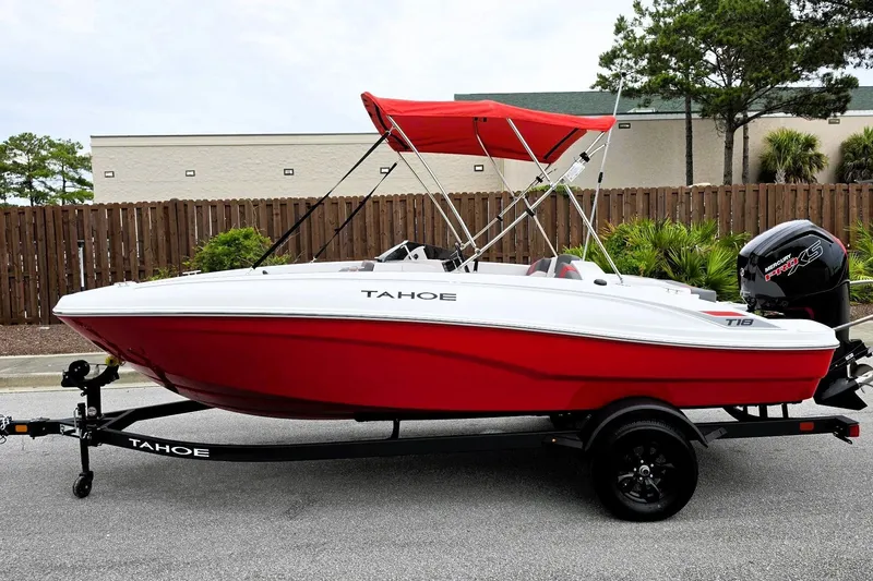 Slide: The Image of 2027 Tahoe T18 boat with red hull and canopy on a trailer. - 8