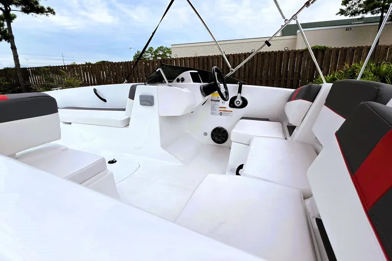 Slide: The Image of 2027 Tahoe T18 boat interior with white and gray seating, steering wheel, and modern design. - 15