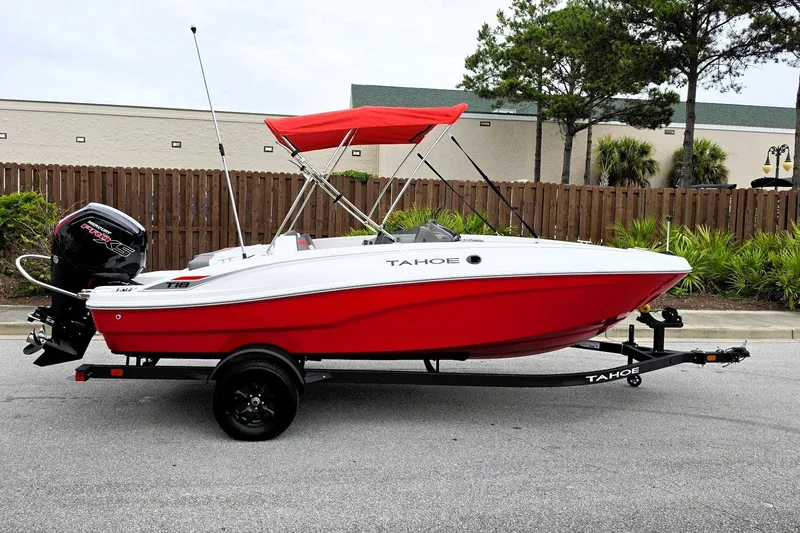 The Image of 2027 Tahoe T18 boat with red hull and canopy on a trailer. - 0