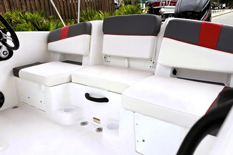 Slide: The Image of 2027 Tahoe T18 boat interior with white and gray seating, red accents. - 16