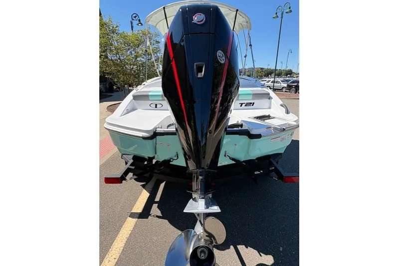Slide: The Image of 2027 Tahoe T21 boat with powerful outboard motor, parked on a sunny day. - 7