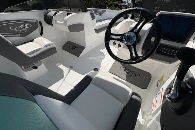 Slide: The Image of 2027 Tahoe T21 boat interior with sleek white seating and modern steering wheel design. - 3