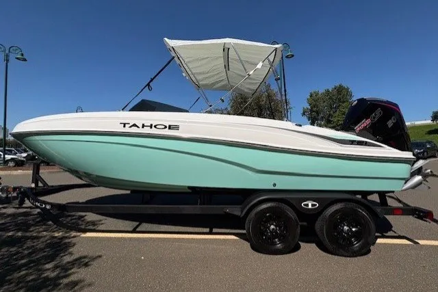 The Image of 2027 Tahoe T21 boat with canopy on trailer, parked outdoors. - 0