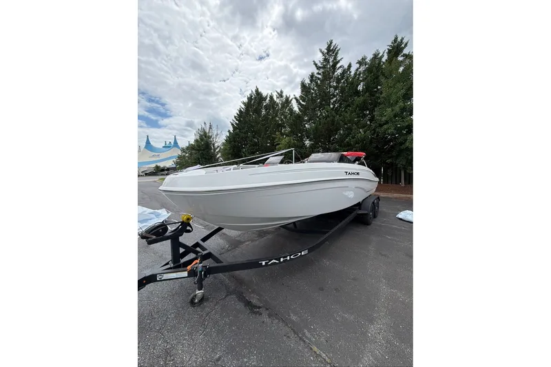 Slide: The Image of 2027 Tahoe T21 boat on trailer, parked outdoors under cloudy sky. - 1