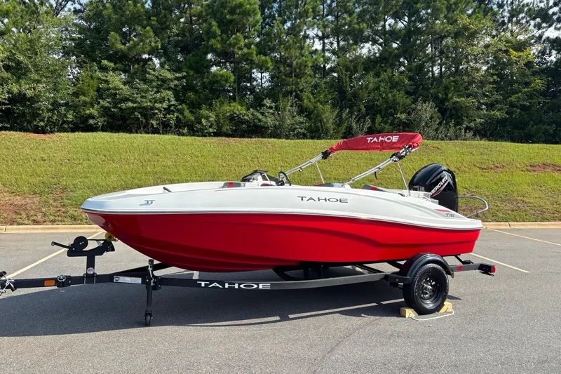 Slide: The Image of 2027 Tahoe T16 boat with red and white design on a trailer, parked outdoors. - 1