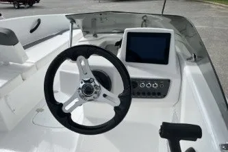 Slide: The Image of 2027 Tahoe T16 boat dashboard with steering wheel and digital display. - 5