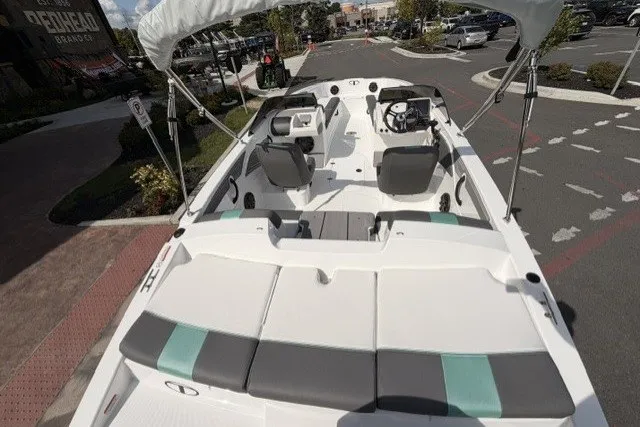 Slide: The Image of 2027 Tahoe T21 boat with spacious seating and modern design in a parking area. - 3