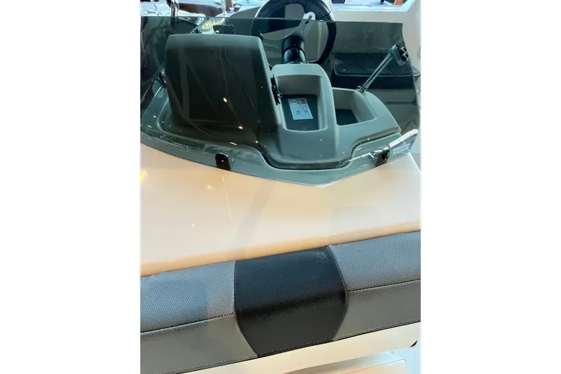 Slide: The Image of 2027 Tahoe T18 boat dashboard with steering wheel and seating detail. - 7