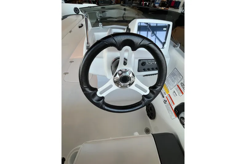 Slide: The Image of Steering wheel and dashboard of 2027 Tahoe T18 boat, featuring modern controls and display. - 5