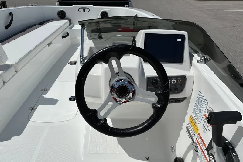 Slide: The Image of Steering console of a 2027 Tahoe T18 boat with modern controls and seating. - 6