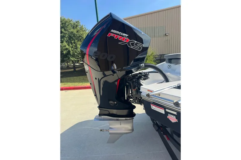 Slide: The Image of 2027 Tahoe T21 boat with Mercury Pro XS outboard motor, parked outdoors. - 4