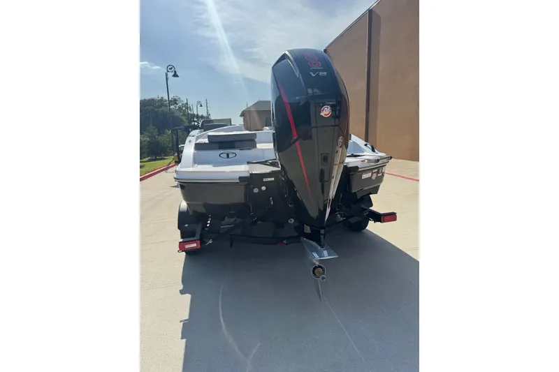 Slide: The Image of 2027 Tahoe T21 boat with powerful V8 engine, parked outdoors on a sunny day. - 3