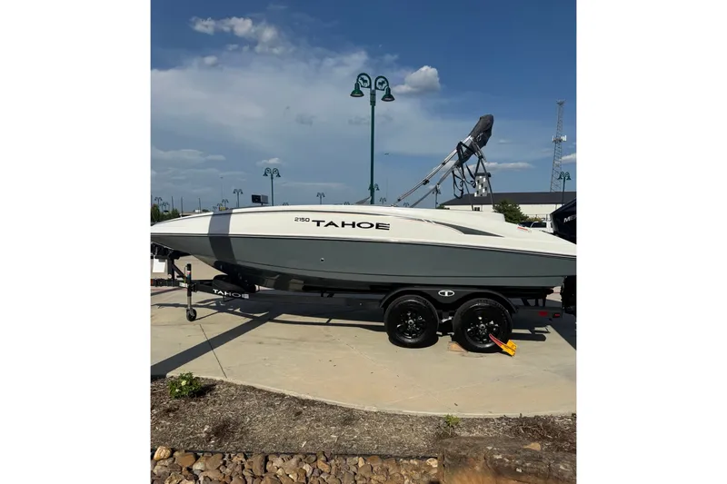 The Image of 2027 Tahoe T21 boat on trailer under clear blue sky. - 0
