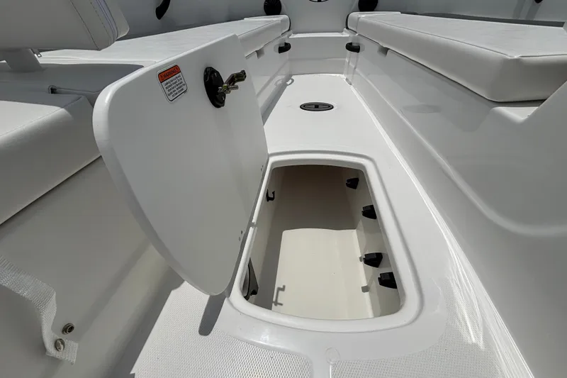 Slide: The Image of Open storage compartment on 2027 Tahoe T18 boat, showcasing interior space and seating. - 14
