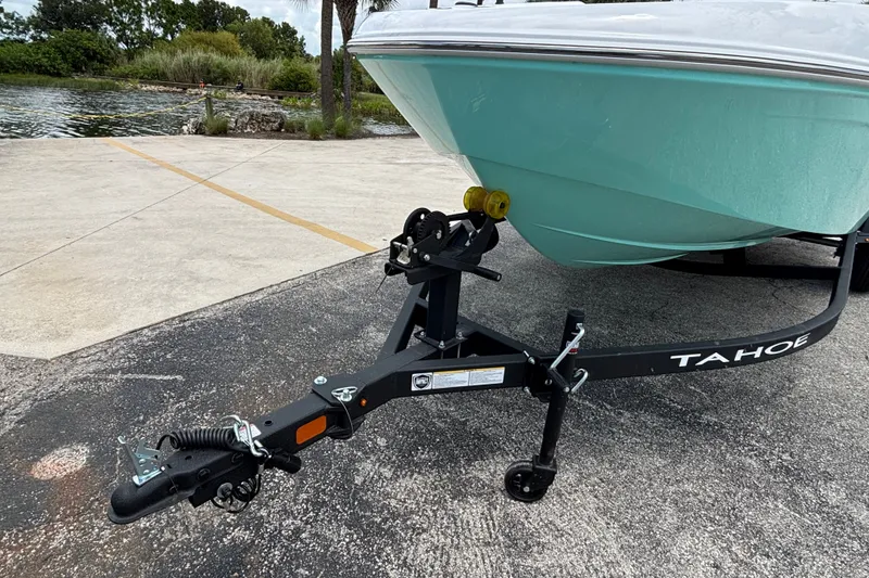 Slide: The Image of 2027 Tahoe T18 boat on trailer near water, showcasing sleek design and sturdy build. - 9