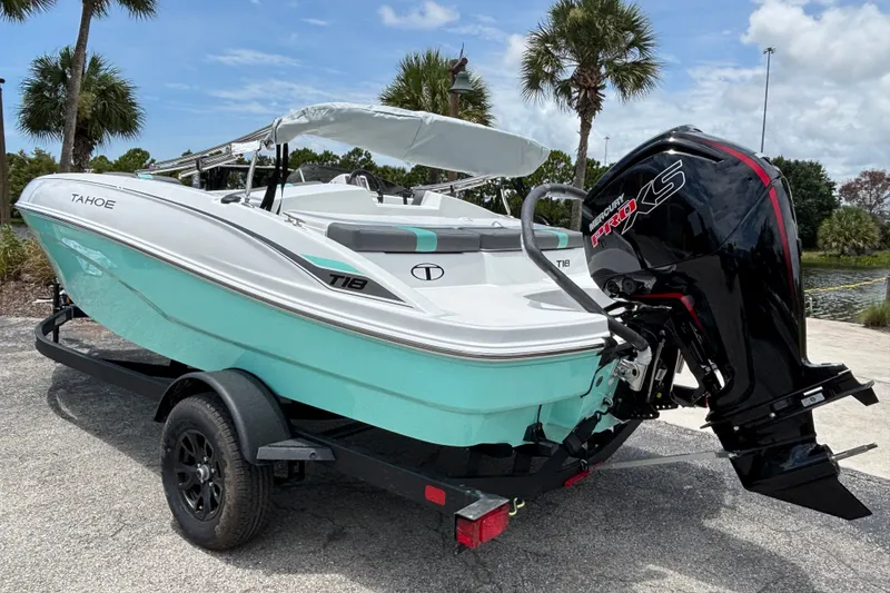 Slide: The Image of 2027 Tahoe T18 boat with Mercury Pro XS engine on trailer, parked near palm trees. - 4