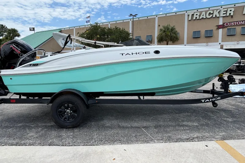 The Image of 2027 Tahoe T18 boat on trailer, displayed outdoors near a dealership. - 0