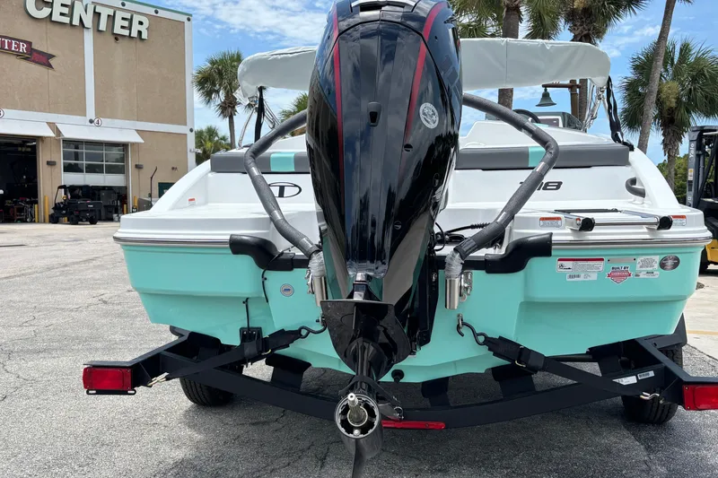 Slide: The Image of 2027 Tahoe T18 boat on trailer, parked outside a service center. - 7