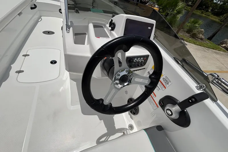 Slide: The Image of 2027 Tahoe T18 boat cockpit with steering wheel and control panel. - 13