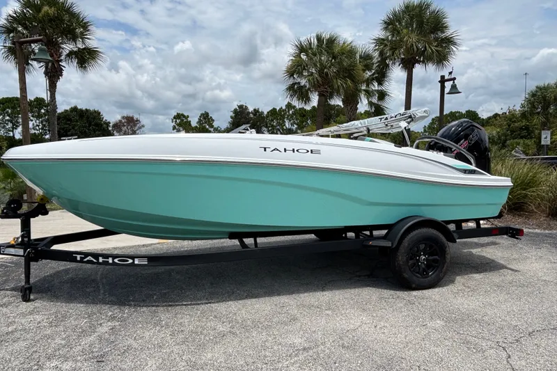 Slide: The Image of 2027 Tahoe T18 boat on trailer, parked outdoors with palm trees in background. - 3