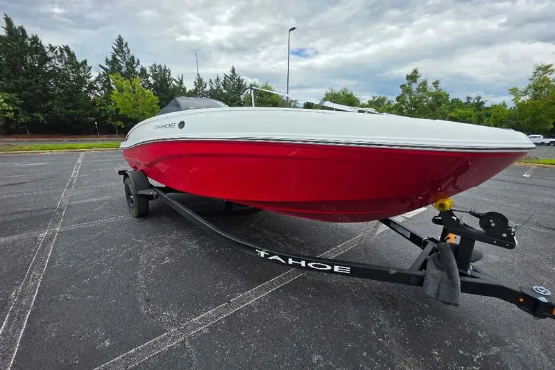 Slide: The Image of Red and white 2027 Tahoe T18 boat on trailer in parking lot. - 6