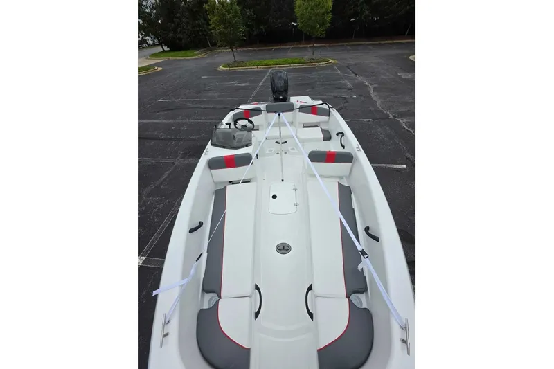 Slide: The Image of 2027 Tahoe T18 boat in parking lot, featuring sleek white and gray design. - 13