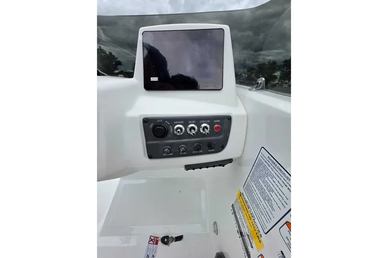 Slide: The Image of Dashboard of 2027 Tahoe T18 boat with control panel and display screen. - 12